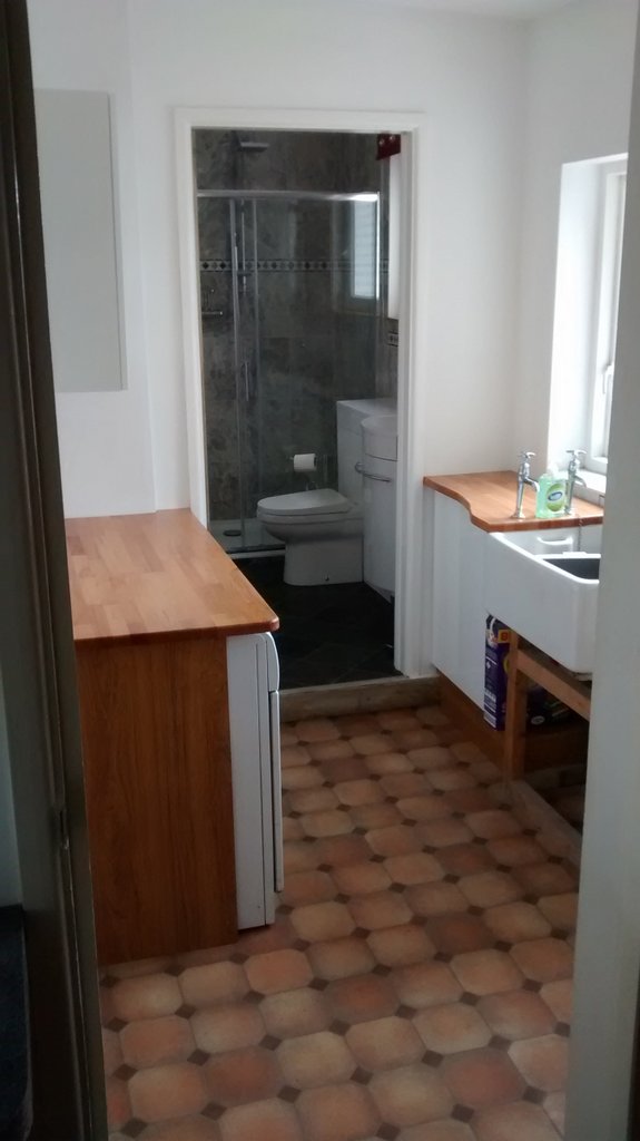 Adjacent to the kitchen is a utility room with a Belfast sink - good for washing wetsuits - and wood block surfaces. There is a modern washing machine and a condensing tumble dryer. 
